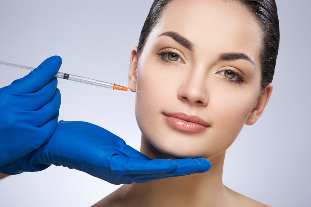 Young,Woman,Looking,At,Camera.,Cheek,Operated,By,Plastic,Surgeon.